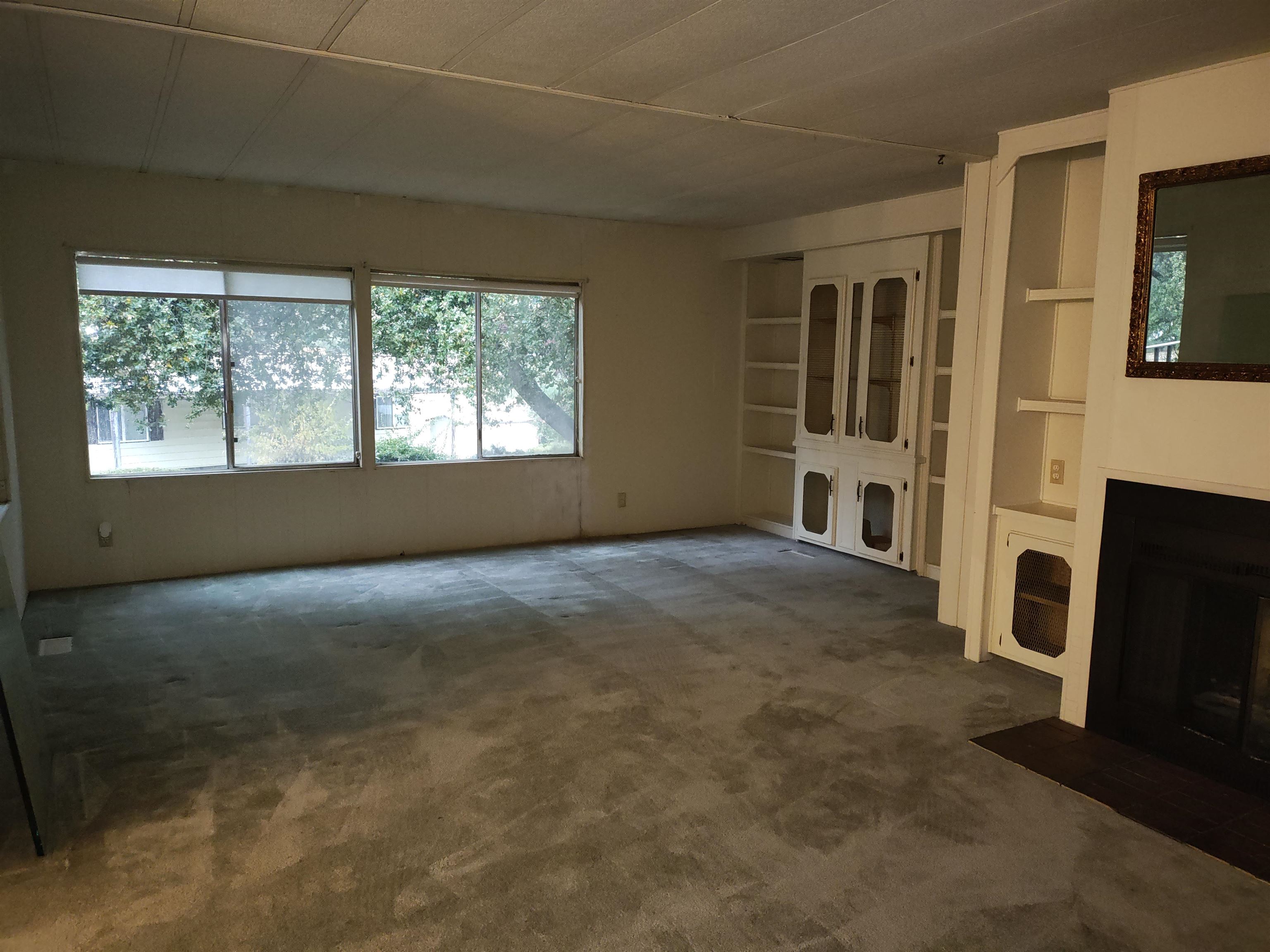 10956 Green Street, Unit 152 Columbia, CA 95310 - Photo 36 of 46 a view of a livingroom with an empty space and a fireplace