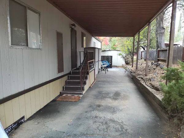 a hallway with stairs and a yard