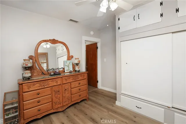 a room with painting on the wall and a dresser