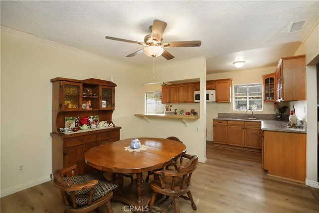 a kitchen with stainless steel appliances granite countertop a sink dishwasher a stove a refrigerator with island cabinets and wooden floor