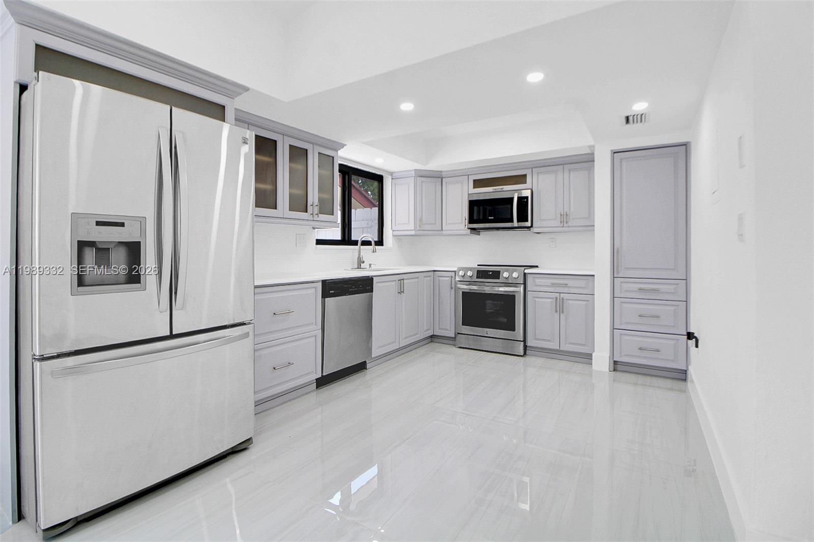 8961 Southwest 6th Street Miami, FL 33174 - Photo 12 of 26 a kitchen with stainless steel appliances granite countertop a refrigerator and a stove top oven