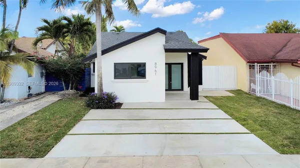 a front view of house with yard and green space