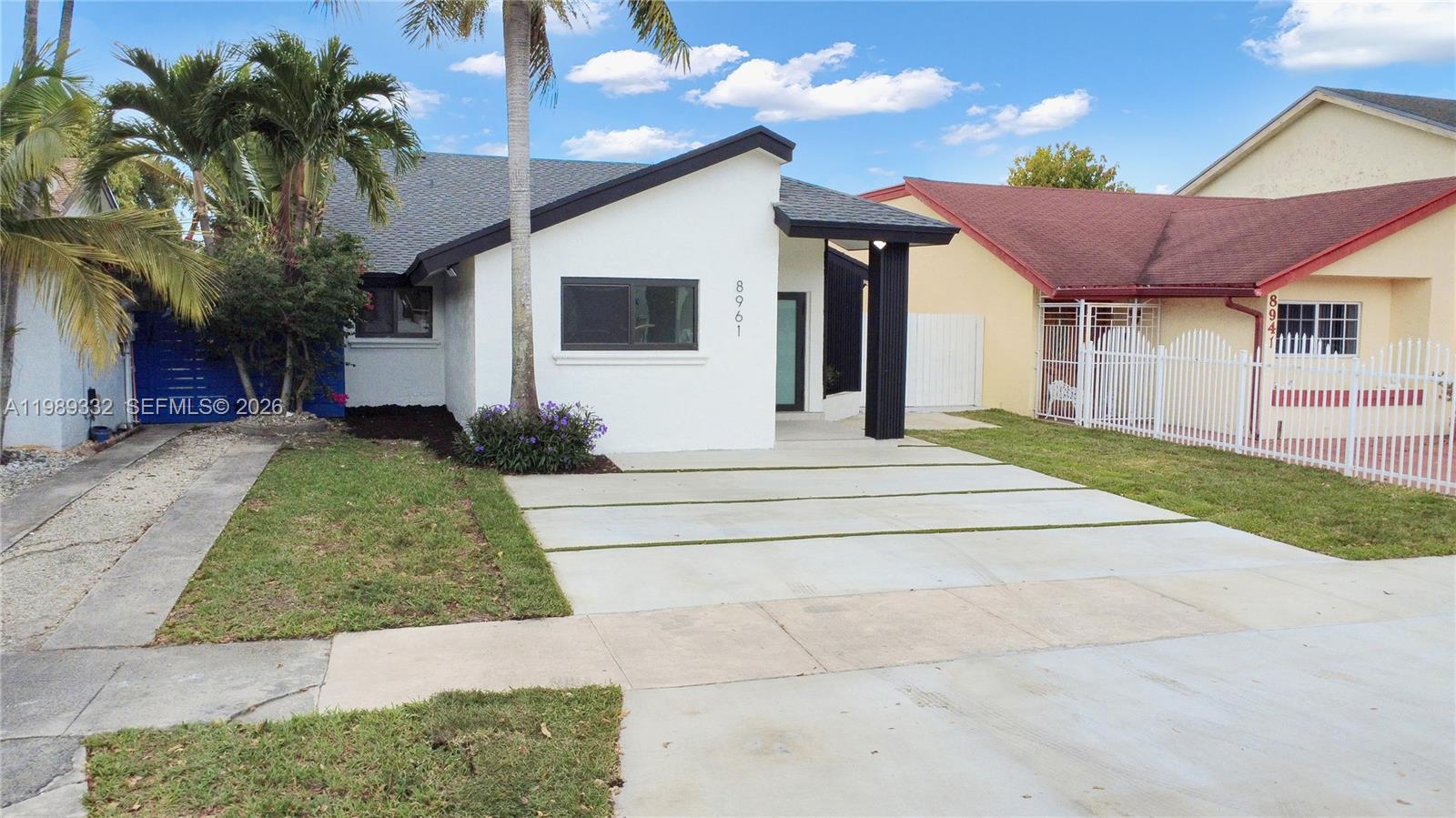 8961 Southwest 6th Street Miami, FL 33174 - Photo 16 of 26 a view of a white house next to a yard with potted plants