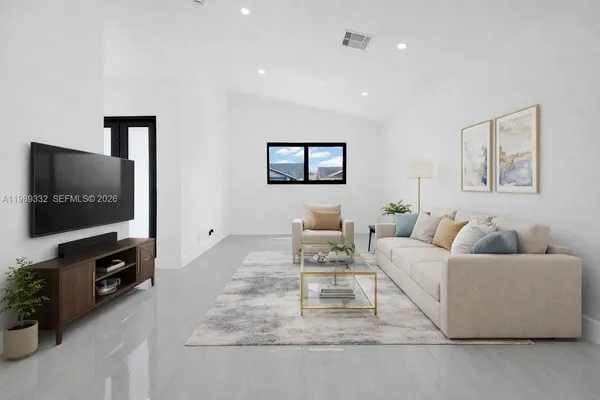 a living room with furniture and a flat screen tv