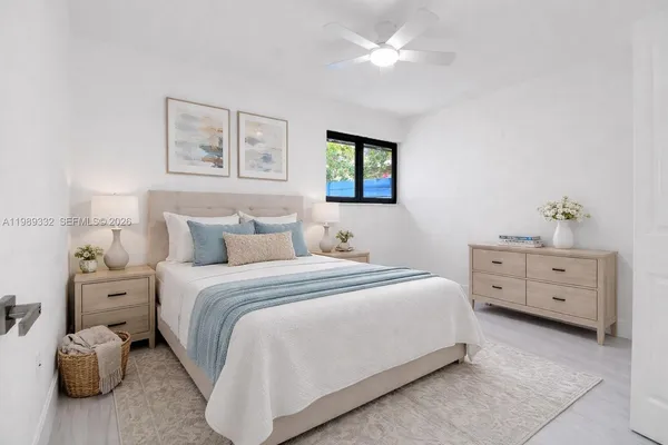 a bedroom with a bed and ceiling fan