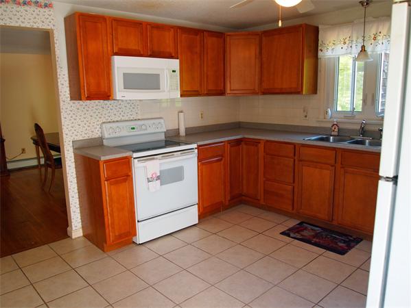 50 Oldham Road Barnstable, MA 02655 - Photo 2 of 11 a kitchen with stainless steel appliances granite countertop a stove a sink and a refrigerator