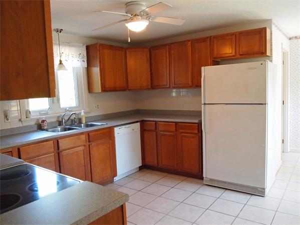 50 Oldham Road Barnstable, MA 02655 - Photo 3 of 11 a kitchen with a refrigerator sink and cabinets