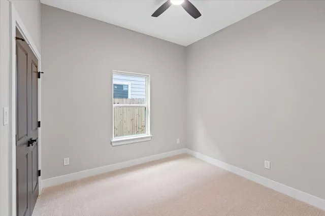 an empty room with windows and cabinet