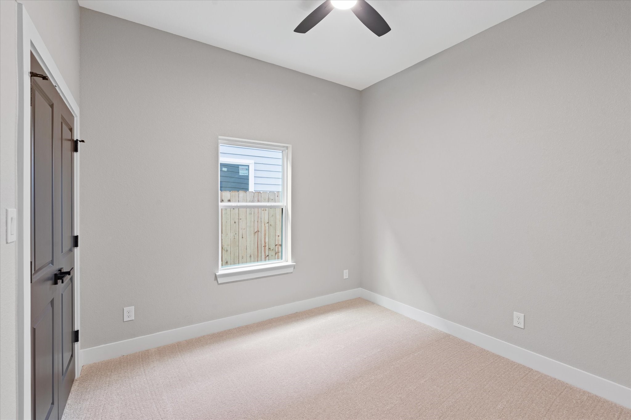 7349 Sandle Street, Unit A Houston, TX 77088 - Photo 11 of 18 an empty room with a window and a ceiling fan