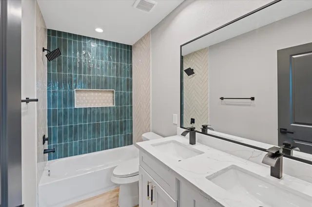 a kitchen with stainless steel appliances granite countertop a sink and a stove