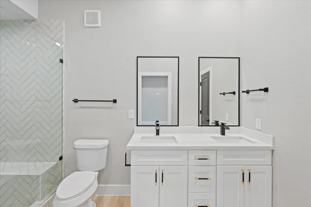 a bathroom with a toilet and shower