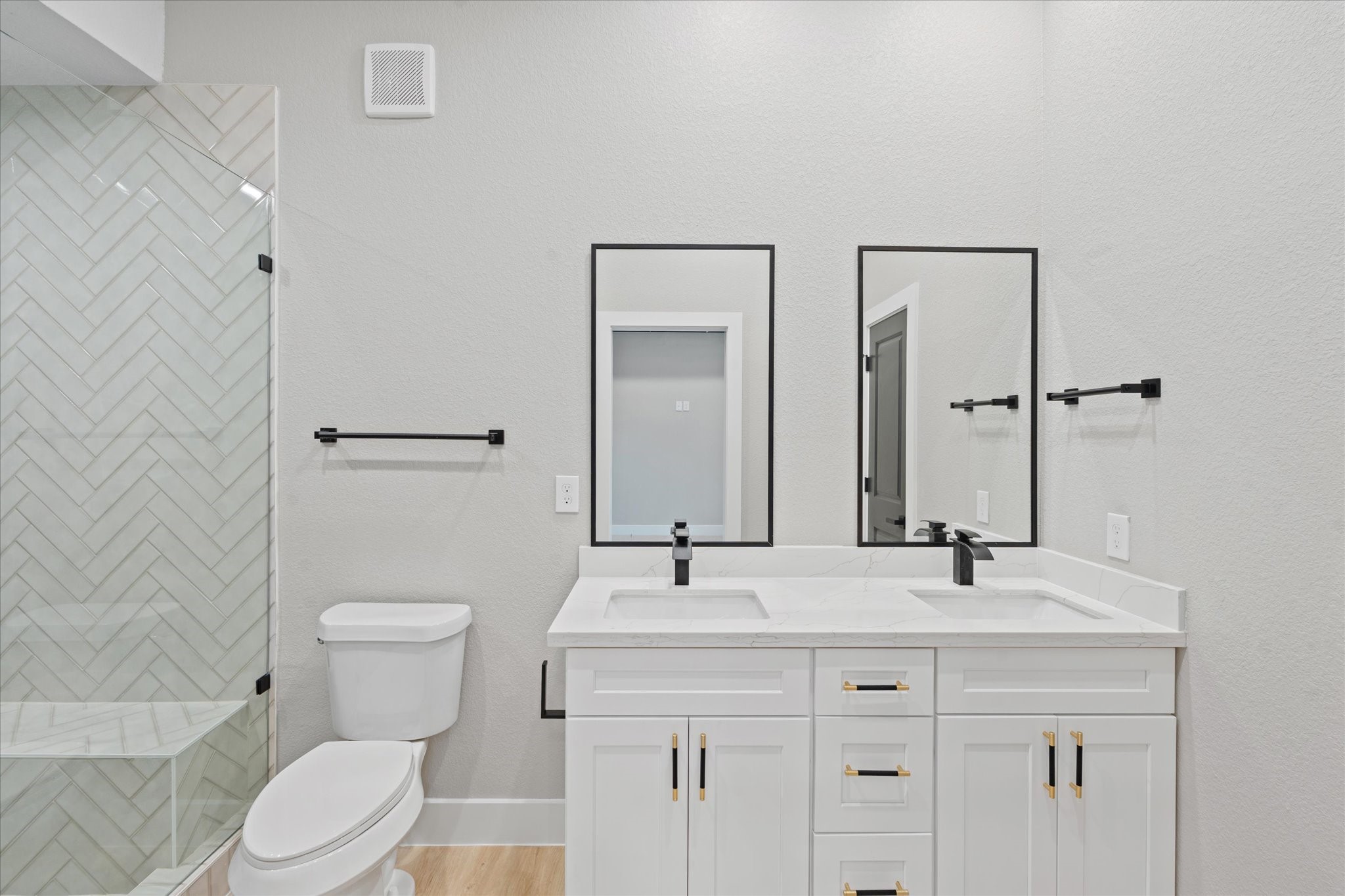 7349 Sandle Street, Unit A Houston, TX 77088 - Photo 9 of 18 a bathroom with a toilet a sink and mirror