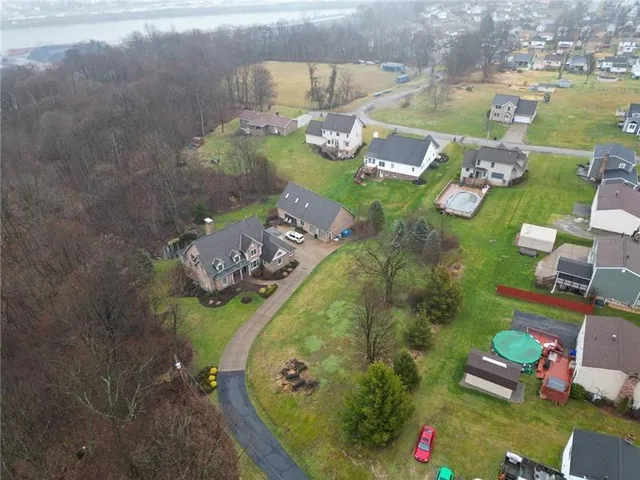 an aerial view of a house with outdoor space