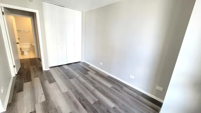 a view of a room with wooden floor and brick walls