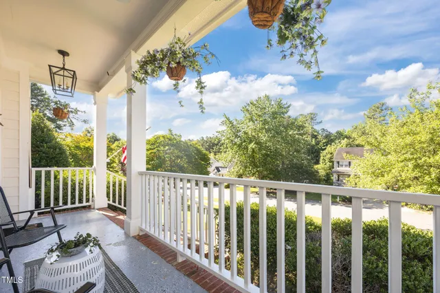 a living room with furniture a fireplace and a large window