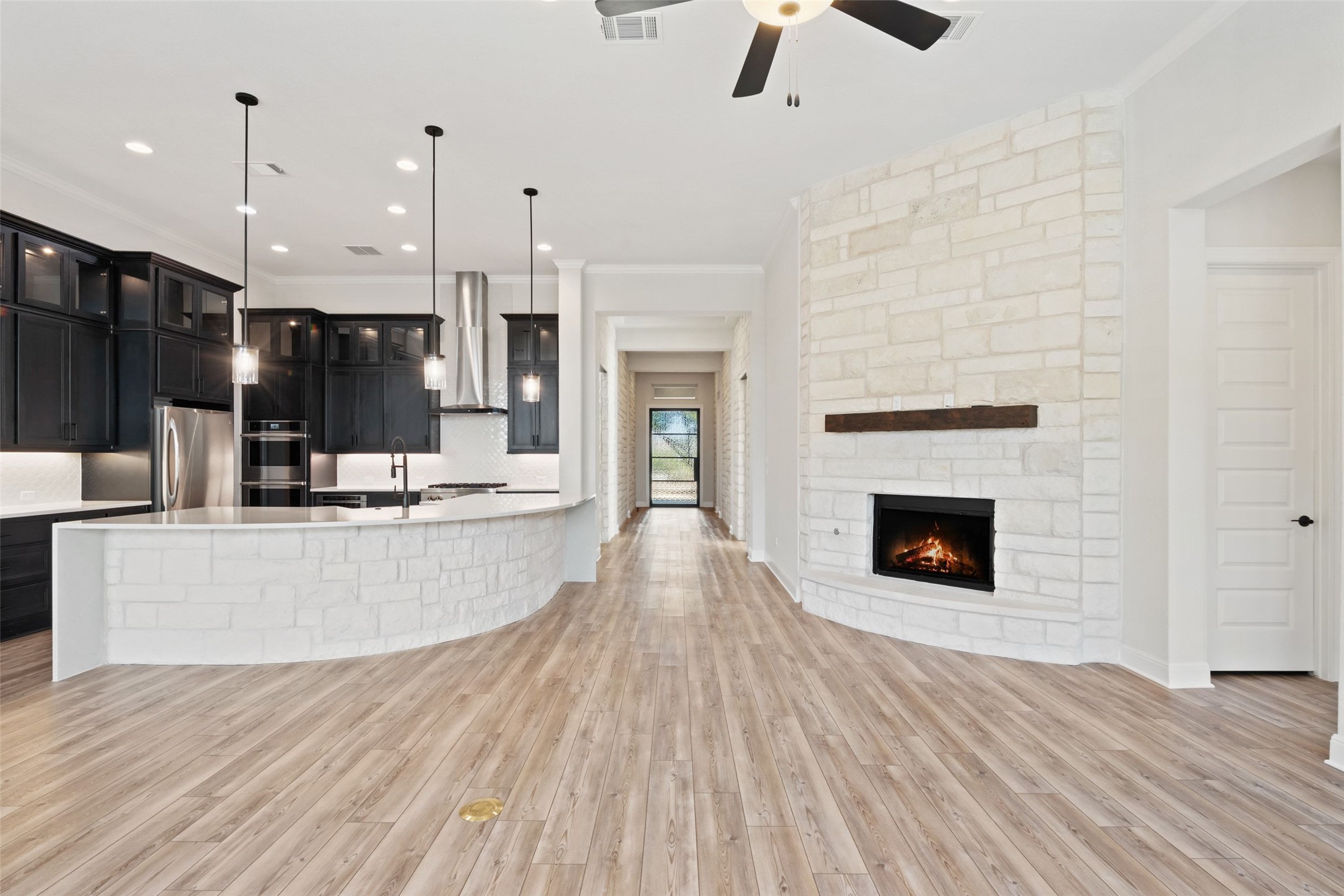 5420 Destination Way Jonestown, TX 78645 - Photo 11 of 40 View from living area looking towards front door and stone fireplace