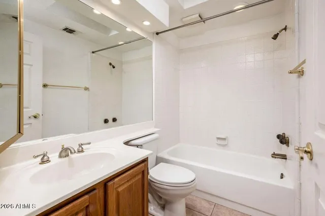 a bathroom with a sink toilet vanity and shower