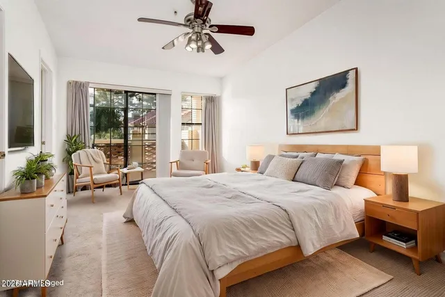 a bedroom with a large bed and a couch