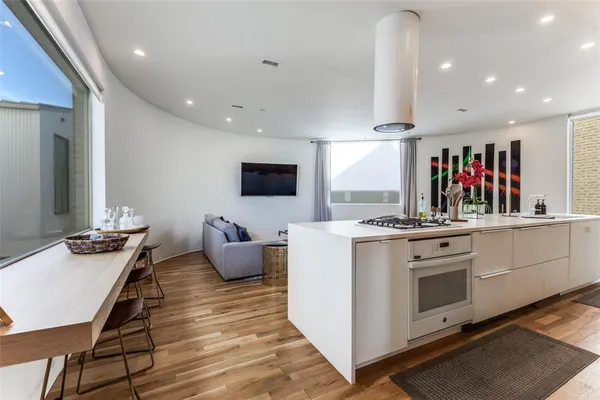 a kitchen with a sink cabinets and wooden floor