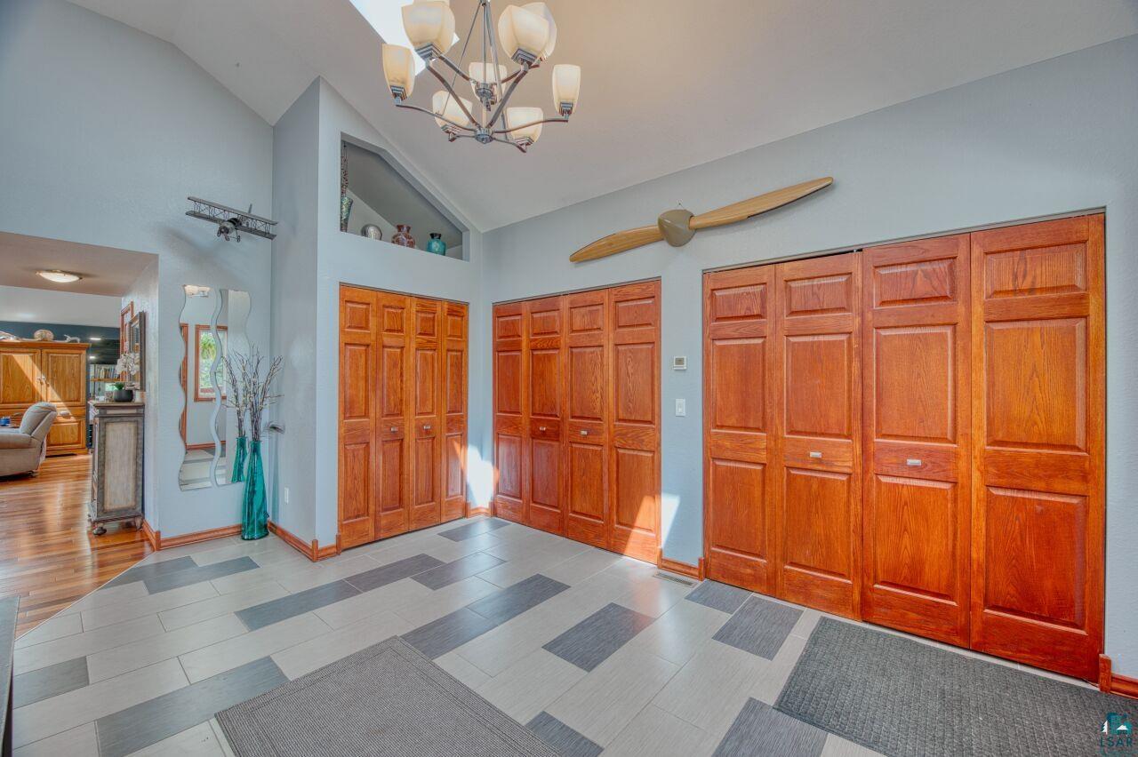 3935 Saari Road Hibbing, MN 55746 - Photo 3 of 48 Interior space with high vaulted ceiling, an inviting chandelier, and tile floors
