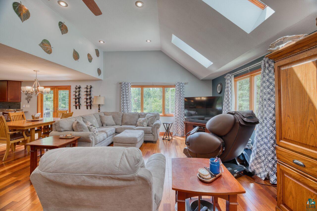 3935 Saari Road Hibbing, MN 55746 - Photo 5 of 48 Living room featuring a healthy amount of sunlight, a notable chandelier, and hardwood / wood-style floors