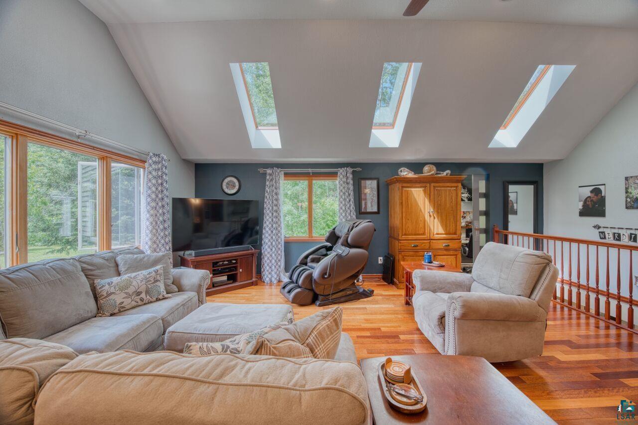 3935 Saari Road Hibbing, MN 55746 - Photo 6 of 48 Living room with high vaulted ceiling, light hardwood / wood-style flooring, and a skylight