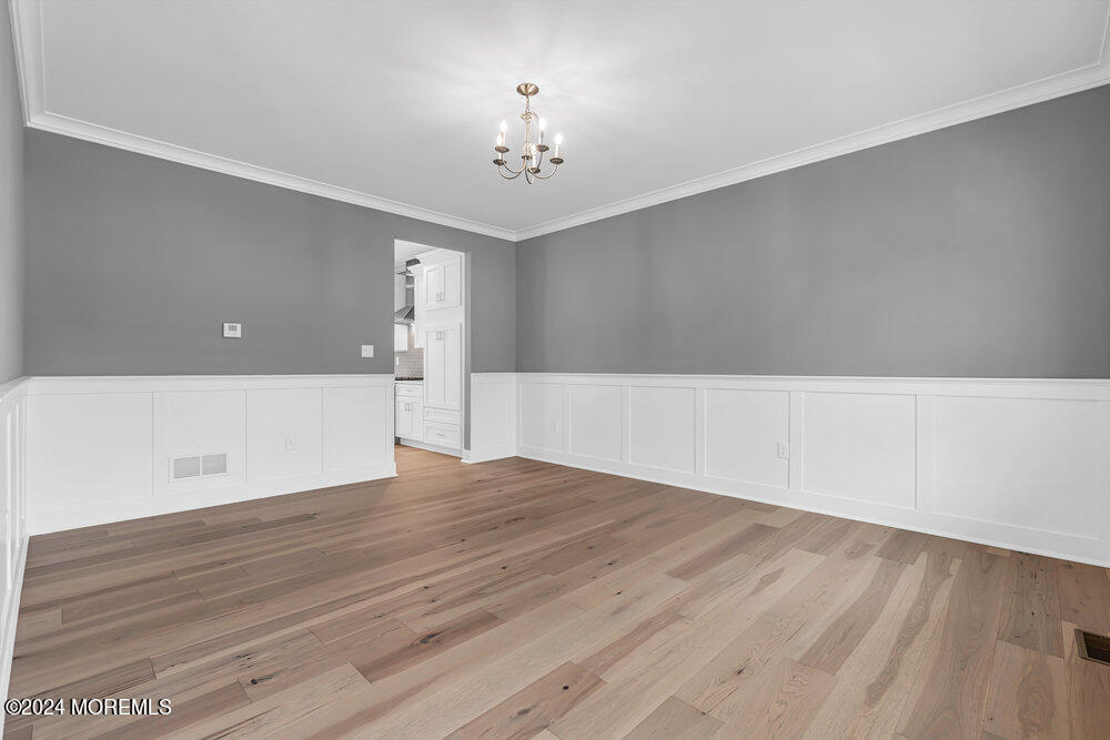 12 Sander Way Bayville, NJ 08721 - Photo 12 of 71 a view of empty room with wooden floor and fan