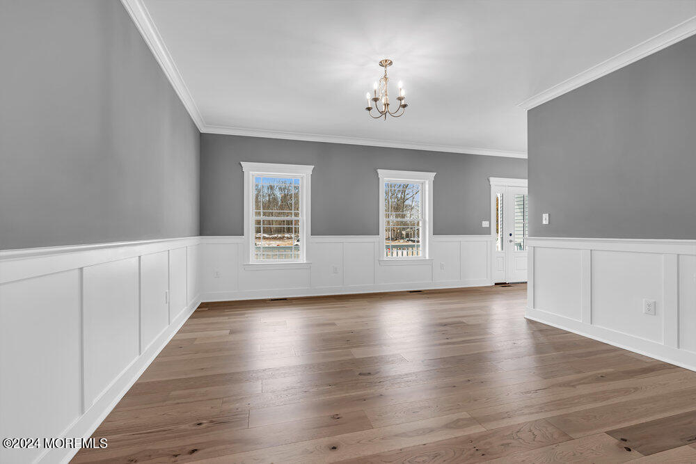 12 Sander Way Bayville, NJ 08721 - Photo 15 of 71 an empty room with wooden floor and chandelier