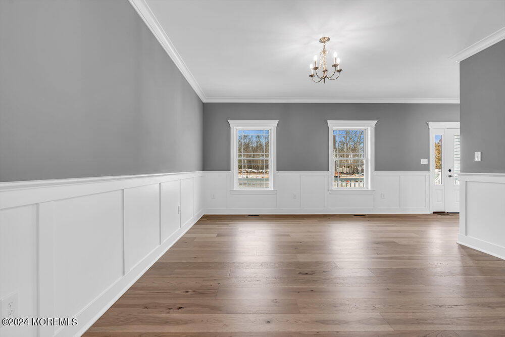 12 Sander Way Bayville, NJ 08721 - Photo 16 of 71 a view of an empty room with a window and wooden floor