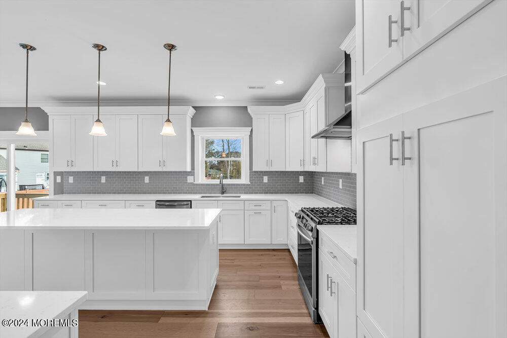 12 Sander Way Bayville, NJ 08721 - Photo 17 of 71 a kitchen with stainless steel appliances granite countertop a sink a stove and a wooden floors