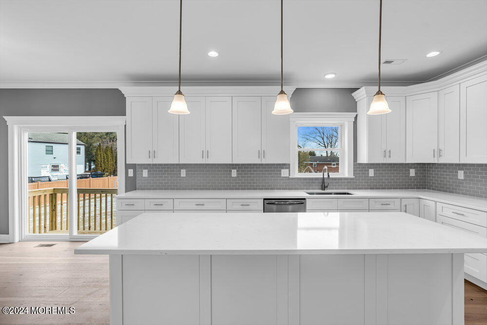 12 Sander Way Bayville, NJ 08721 - Photo 20 of 71 a kitchen with a refrigerator a sink and wooden cabinets