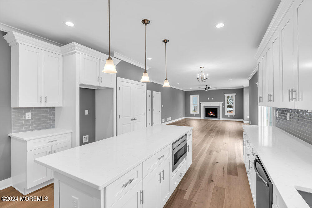 12 Sander Way Bayville, NJ 08721 - Photo 22 of 71 a large kitchen with kitchen island a stove a sink a refrigerator and a fireplace