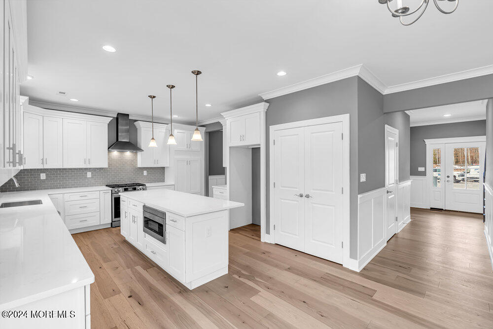 12 Sander Way Bayville, NJ 08721 - Photo 29 of 71 a kitchen that has a lot of white cabinets and stainless steel appliances
