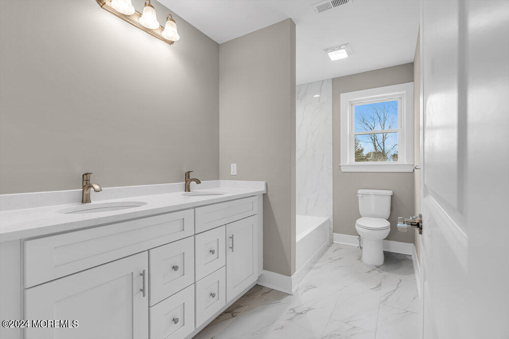 12 Sander Way Bayville, NJ 08721 - Photo 42 of 71 a spacious bathroom with a toilet a sink and mirror