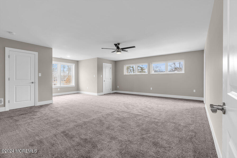 12 Sander Way Bayville, NJ 08721 - Photo 50 of 71 an empty room with windows and ceiling fan