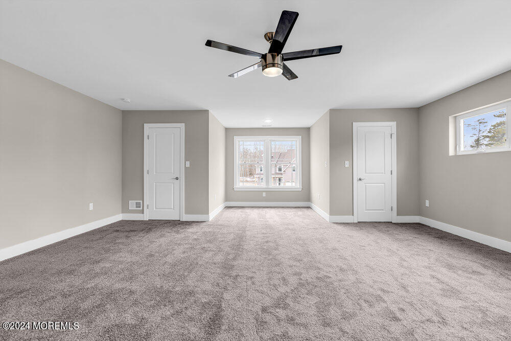 12 Sander Way Bayville, NJ 08721 - Photo 52 of 71 a view of an empty room with a ceiling fan