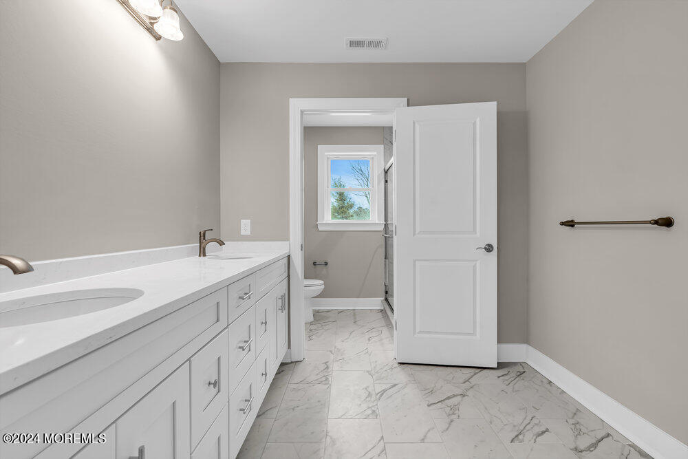 12 Sander Way Bayville, NJ 08721 - Photo 54 of 71 a spacious bathroom with a double vanity sink and a mirror