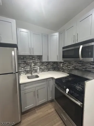 a kitchen with a sink stove and refrigerator