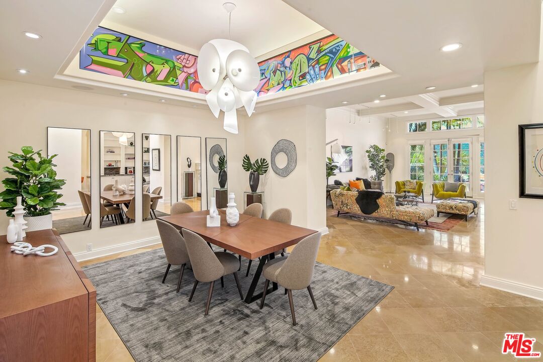 2305 Canyonback Road Los Angeles, CA 90049 - Photo 11 of 50 a view of a dining room with furniture a chandelier and wooden floor