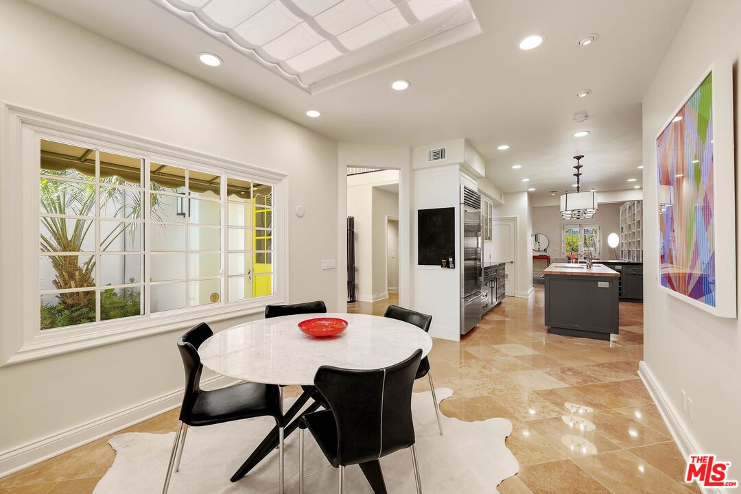 2305 Canyonback Road Los Angeles, CA 90049 - Photo 18 of 50 a large kitchen with a table and chairs