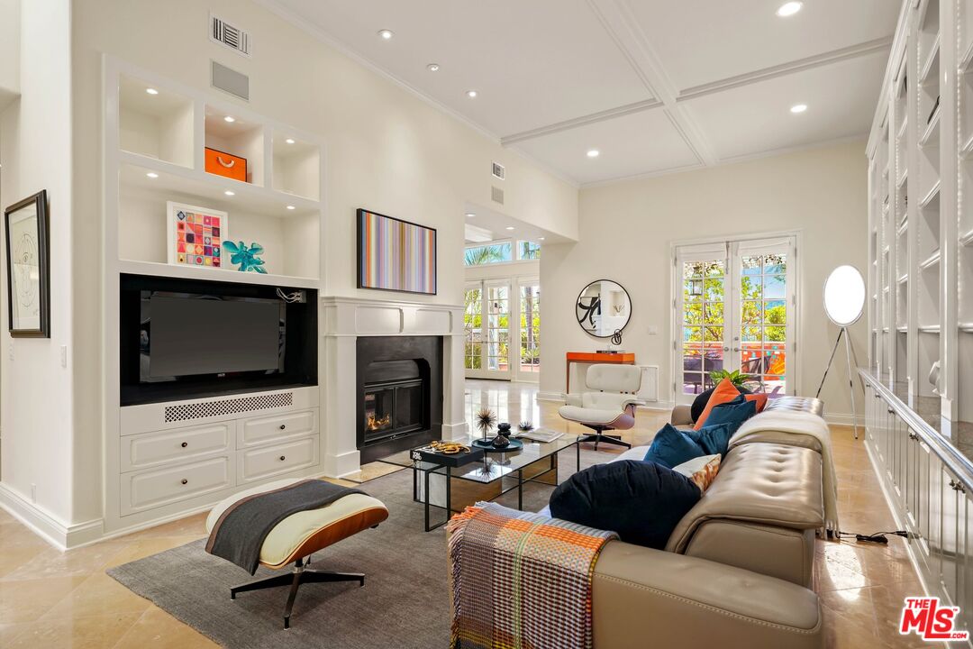 2305 Canyonback Road Los Angeles, CA 90049 - Photo 21 of 50 a living room with furniture a flat screen tv and a fireplace