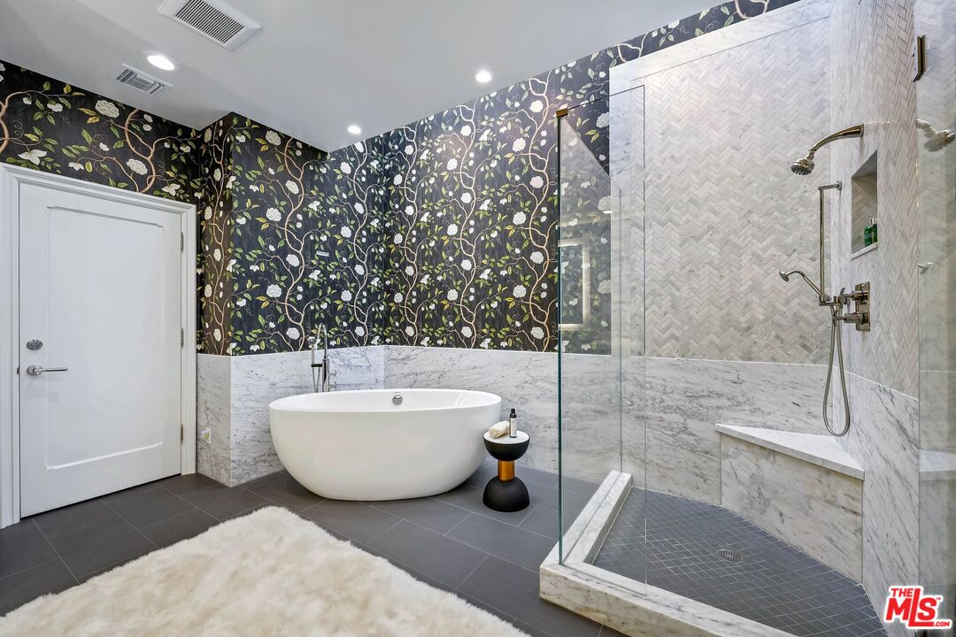 2305 Canyonback Road Los Angeles, CA 90049 - Photo 25 of 50 a spacious bathroom with a bathtub a mirror a sink and shower