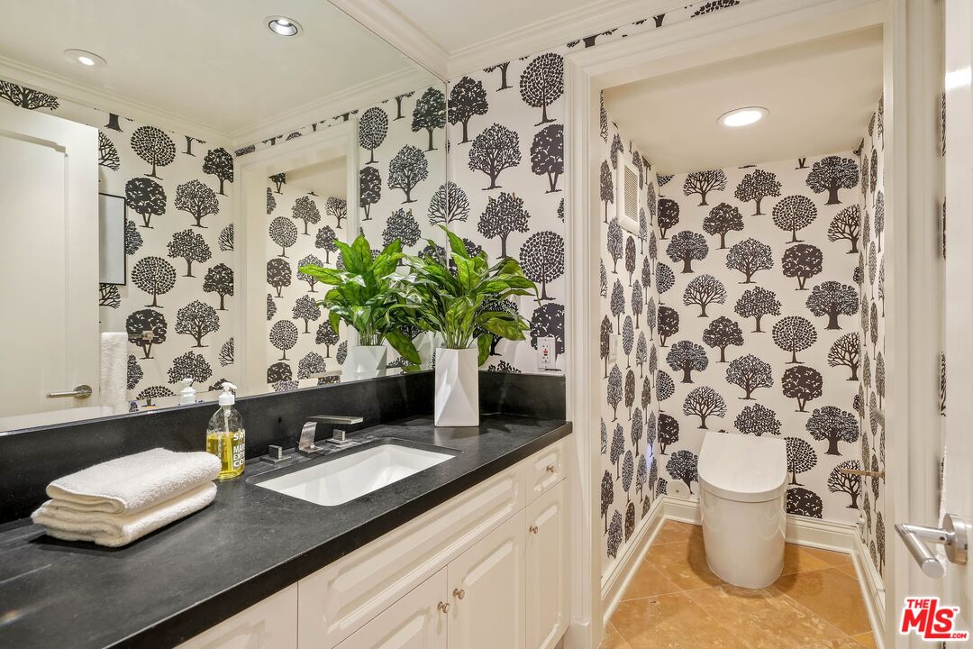 2305 Canyonback Road Los Angeles, CA 90049 - Photo 39 of 50 a bathroom with a sink and a toilet