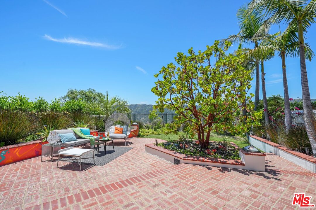 2305 Canyonback Road Los Angeles, CA 90049 - Photo 42 of 50 a view of a backyard with a patio