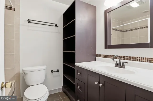 a bathroom with a toilet sink and shower