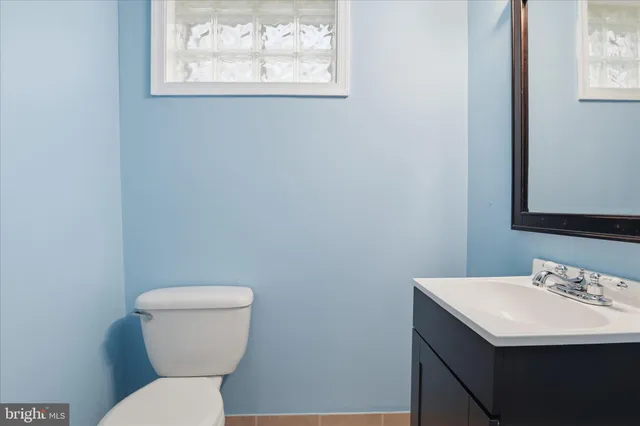 a bathroom with a toilet sink and mirror