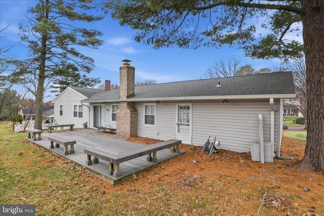 a view of a house with pool and chairs
