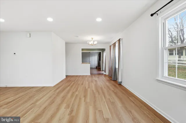 a view of a room with wooden floor and a window