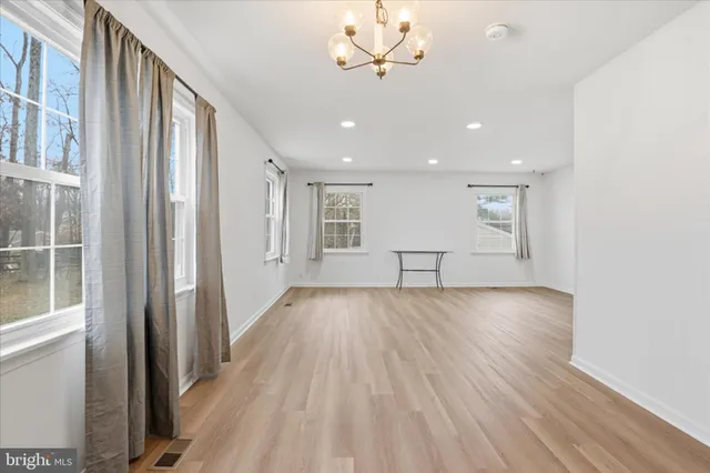 a view of a room with wooden floor and windows