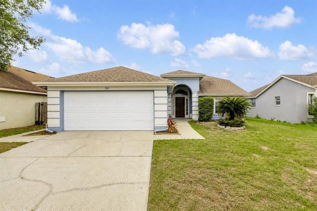 a front view of a house with yard